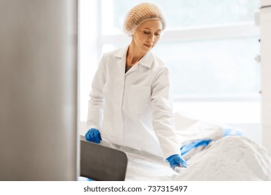 Manufacture, Industry, Food Production And People Concept - Woman Working At Ice Cream Factory Conveyor With Powdered Milk