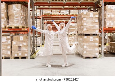 Manufacture, Industry And People Concept - Happy Women Technologists Having Fun At Ice Cream Factory Warehouse