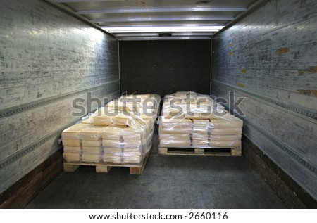 manufactured cheese on pallets in back of refridgerated truck