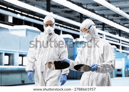 Manufacturing components, semiconductor substrate inspection and team of experts working together, verifying optical lithography patterns, silicon wafer disk and teamworking cleanroom colleagues.