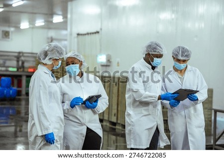 Manufacturing managers perform facility walkthrough and verify sanitation protocol in high volume processing plant. Concept emphasizes food safety governance and audit preparation process.