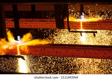 Manufacturing Of Mild Steel Square Bar On Continuous Casting Machine. Cutting Bars By Gas Torch. Hot Bright Metal Sparks.