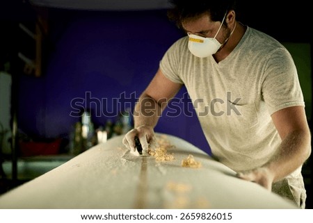 Manufacturing, scraper and man carpenter in workshop for board restoration, hobby or handcraft. Small business, woodwork and male artisan with tool for timber production project in warehouse.