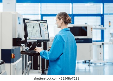 Manufacturing worker checking data of assembly line on screen