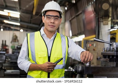 Manufacturing Worker. Professional Asian Worker Controlling The Work. Cheerful Factory Worker Posing.