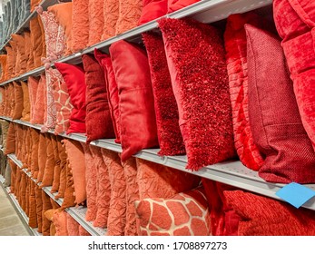 Many Accent Pillow On Display At A Department Store. Red, Orange And Salmon Color Decorative Pillows On Store Shelves.