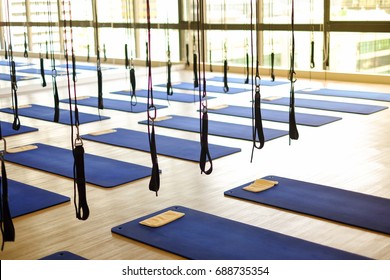 Many aerial yoga exercise equipment with blue cushions in gym for aerial silk (yoga fly) for background or texture - new trend of exercise concept. - Powered by Shutterstock