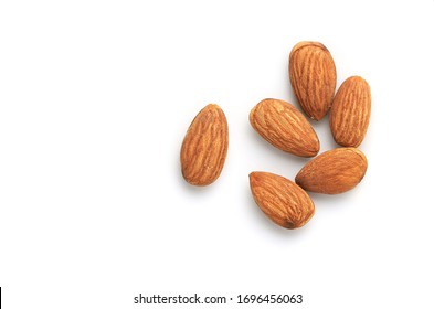 Many Almonds seeds isolate on a white background. Top view and clipping path