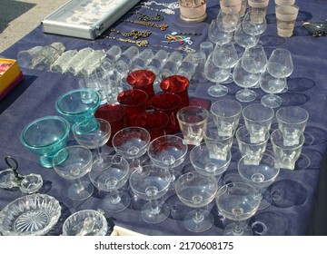 Many Antique Glass Glasses And Other Vintage Trinkets For Sale At The Local Flea Market Stall