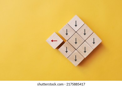 Many arrows point in one direction, and one moves in the other direction. A symbol of choosing a different path in business and life - Shutterstock ID 2175885417