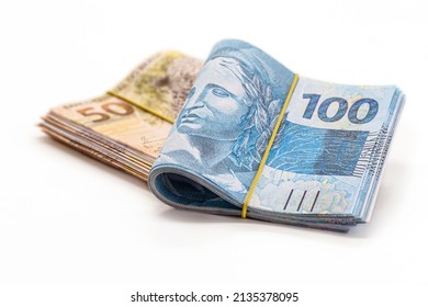 many banknotes of 100 and 50 reais, brazilian money, thousand reais, payment, salary, on isolated white background