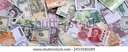 Many banknotes of different currency. Background of big amount of random money bills close up