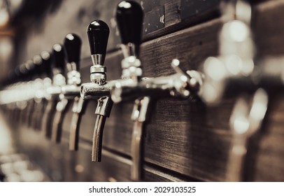 Many Beer Taps In Bar Or Pub. Tap Room