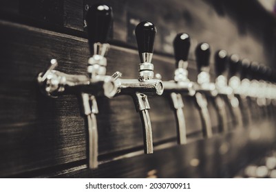 Many Beer Taps In Bar Or Pub. Tap Room