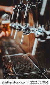 Many Beer Taps In Bar Or Pub. Tap Room