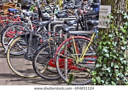 Similar – Fahrräder in der Nähe von niederländischen Häusern in Amsterdam City