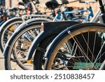 Many bicycles parked at a public bike rack in Copenhagen. Bike parking in Copenhagen. Concept of sustainable transportation and modern urban living in Denmark