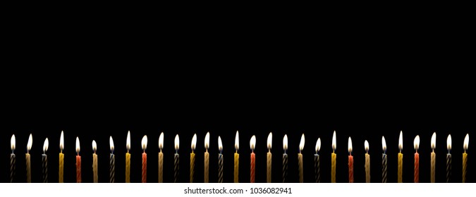 Many birthday candle with lighting in the darkness with copy space