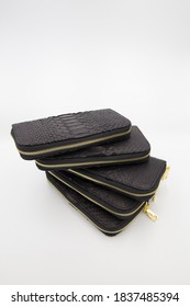 Many Black Snakeskin Wallets Purse In A Row Isolated On A White Background. Fashion Concept.