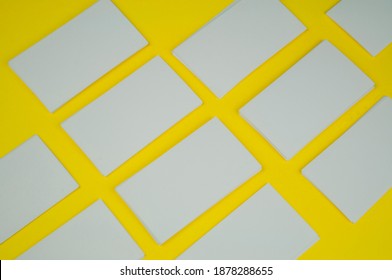 Many Blank White Mokap Business Cards On A Yellow Background