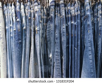 many blue jeans on the rack in shop 


 - Shutterstock ID 1318319204