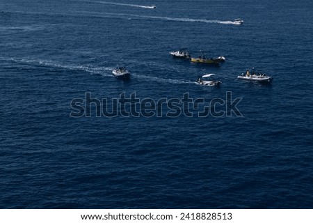 many boats with tourists sailing on the sea. sea trip.