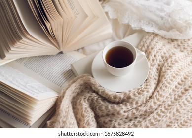 Many books  on the bed and a cup of coffee. - Shutterstock ID 1675828492