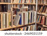 Many books on the shelves of a library