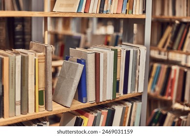 Many books on the shelves of a library