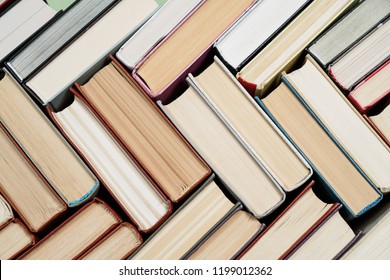 Many Books Piles. Hardback books on wooden table. Back to school. Copy space - Shutterstock ID 1199012362