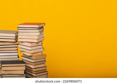 many books stacked in the library on yellow background science knowledge reading