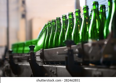 Many bottles on conveyor belt in factory - Powered by Shutterstock