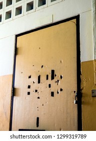 Many Broken Holes On The Old Classroom Door Are Locked