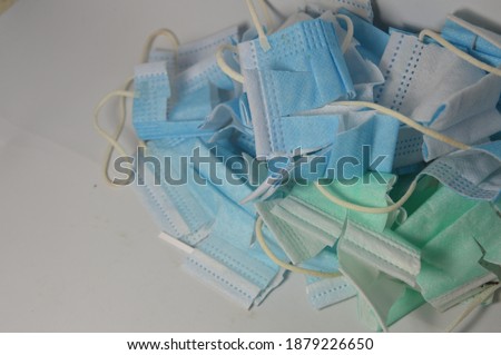 many broken unused disposable mask with blue, white and green colors
