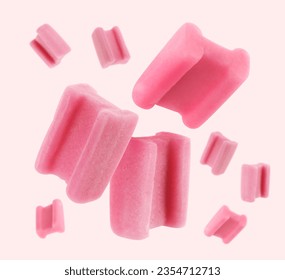 Many bubble gum pillows falling on light background