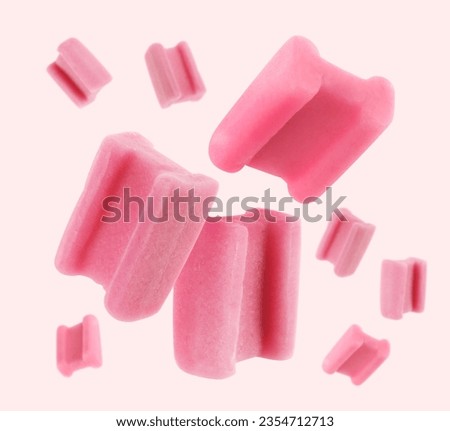 Many bubble gum pillows falling on light background