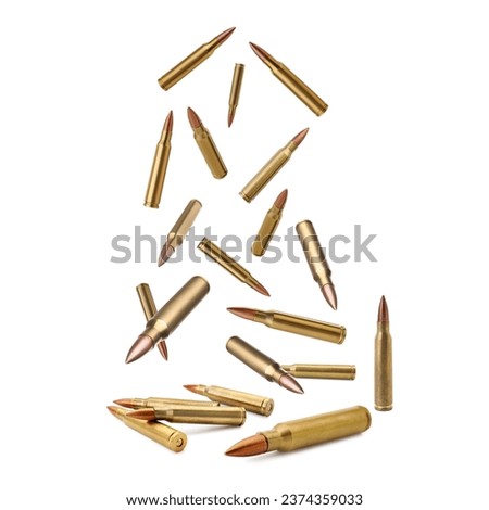 Many bullets falling on white background. Firearm ammunition