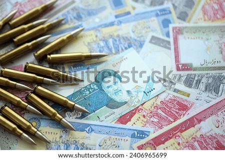 Many bullets and iranian rials money bills close up. Concept of terrorism funding or financial operations to support war in Iran