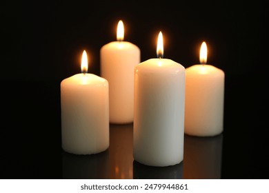 Many burning candles on mirror surface against black background - Powered by Shutterstock