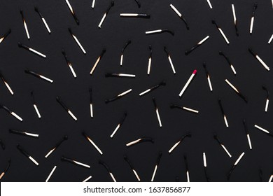 Many Burnt Matches And One Unburnt Match On A Black Background.