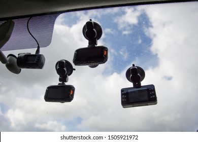 Many Car Dash Cam (DVR) Mounted On The Dirty Front Windshield, Recording The Traffic Ahead In Case Of An Emergency Situation Or An Accident