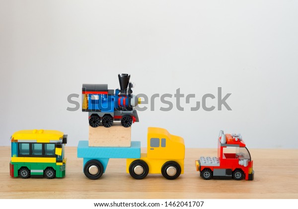 Many of car toy on wood table is about\
to send happiness to children in the dream\
world.