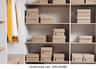 Many Cardboard Boxes On Shelves In Wardrobe