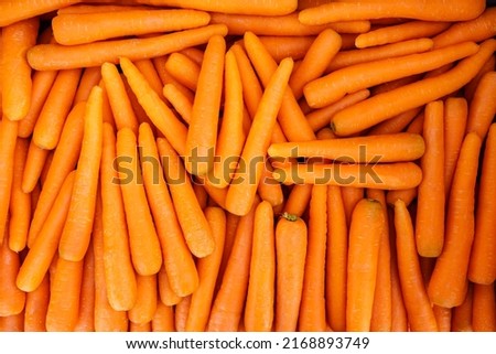 Many carrots placed raw in a container, overhead photo