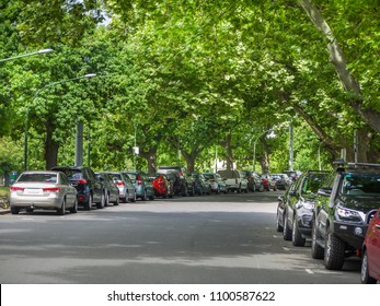 Many Cars Parked And Lined Up Under Trees On Urban Street. City Of Melbourne, VIC Australia.