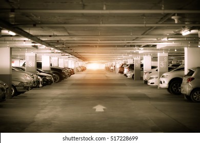 Many cars in parking garage interior, industrial building. Vintage filter effect.