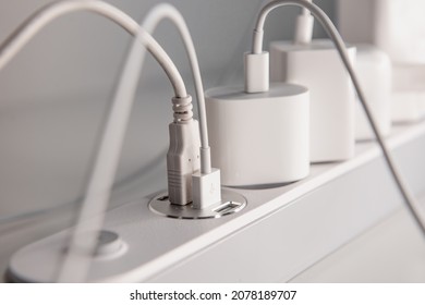 Many chargers plugged into maltiple electrical outlet on white background. Concept of electricity consumption. - Shutterstock ID 2078189707