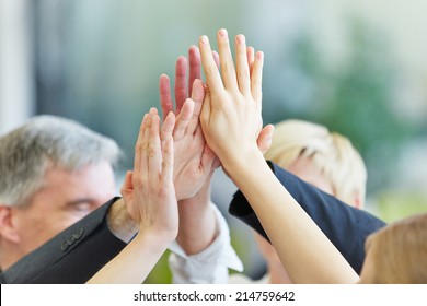 Many cheering hands giving High Five in the business office - Powered by Shutterstock