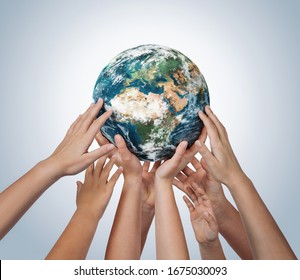 Many children hands holding planet earth isolated on blue background with copy space - Powered by Shutterstock