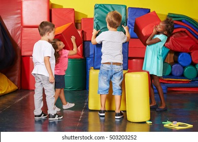 Many children helping together to tidy up in a preschool gym - Powered by Shutterstock